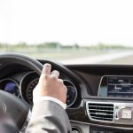Close-up of businessman driving car