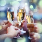 People holding glasses of champagne making a toast