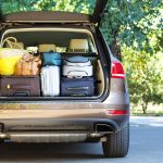 Suitcases and bags in trunk of car ready to depart for holidays
