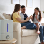 Modern,Air,Humidifier,And,Blurred,Family,On,Background