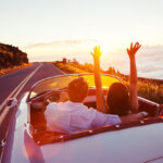 Romantic Couple Driving on Beautiful Road at Sunset